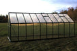 Sturdy Grandio Ascent 8x20 greenhouse with a reinforced aluminum frame and polycarbonate panels, set in a serene field.