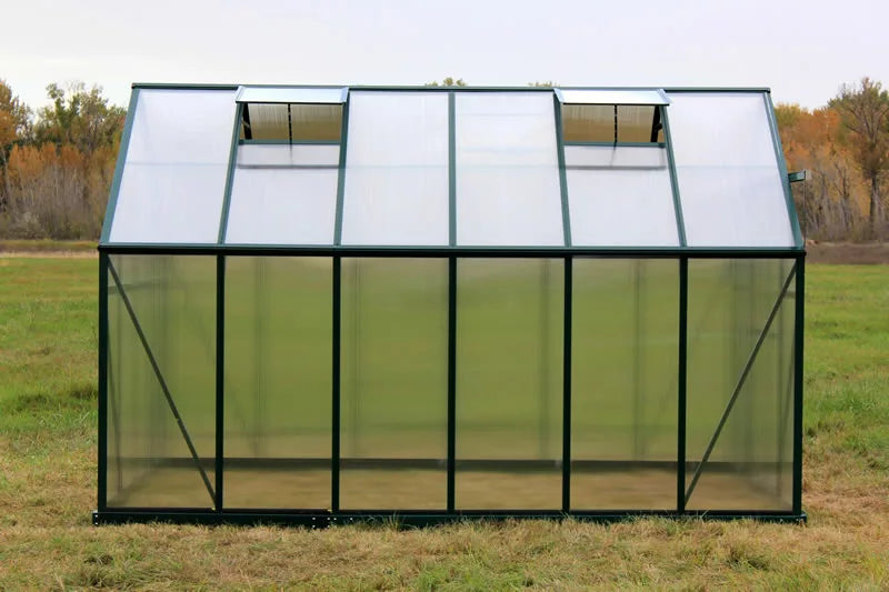 Side view of an 8x12 Grandio Elite greenhouse showing the robust structure and easy-access windows, ideal for sustainable gardening.