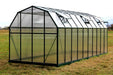 Rear angle of a grand 8x20 Grandio Elite greenhouse, showcasing the sturdy build and protective coverings, optimizing plant growth.