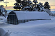 Durable Grandio greenhouse standing strong amidst a snowy landscape, demonstrating winter resilience.