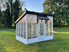 white lean to greenhouse on grass field
