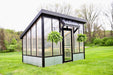 Lean to greenhouse in grass field 